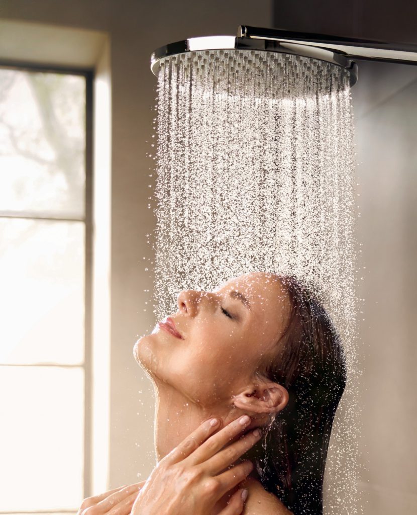 Woman using BETTER EUROPE energy saving showerheads